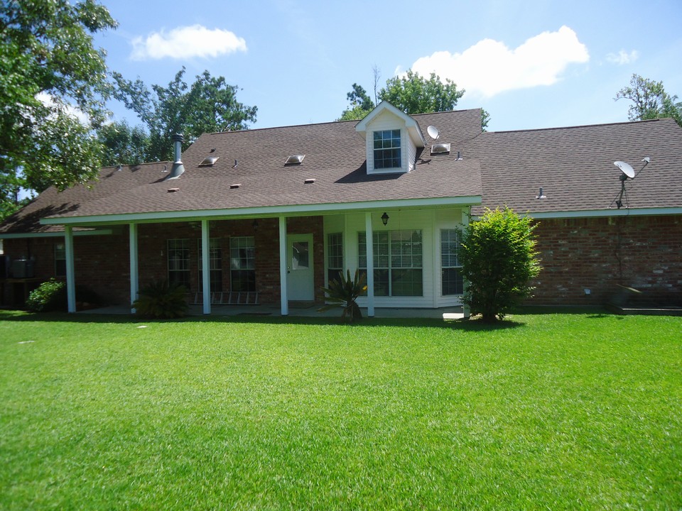 rear of home. enjoy backyard with cover patio and parklike setting