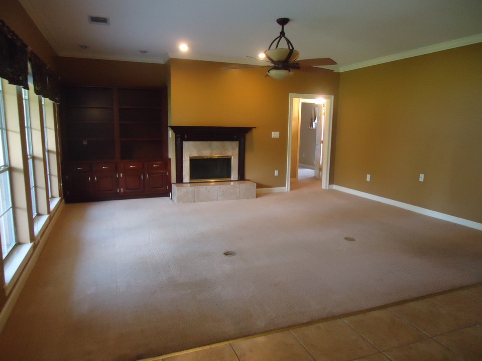 fabulous family room family room has fireplace with ceramic surround, built-in cherry bookshelves, recessed lighting, and a wall of windows that overlooks an incredible backyard and covered patio.