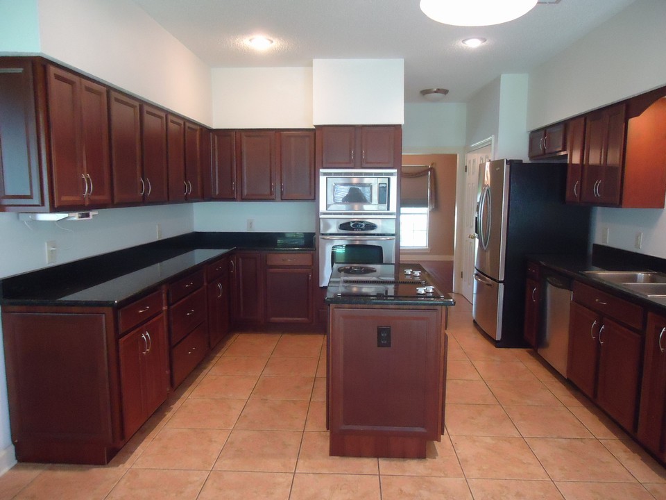 chef's delight!! ample sized kitchen is a chef's dream. granite countertops with extensive space. cooktop with down draft. stainless steel appliance package including refrigerator. neutral colors.